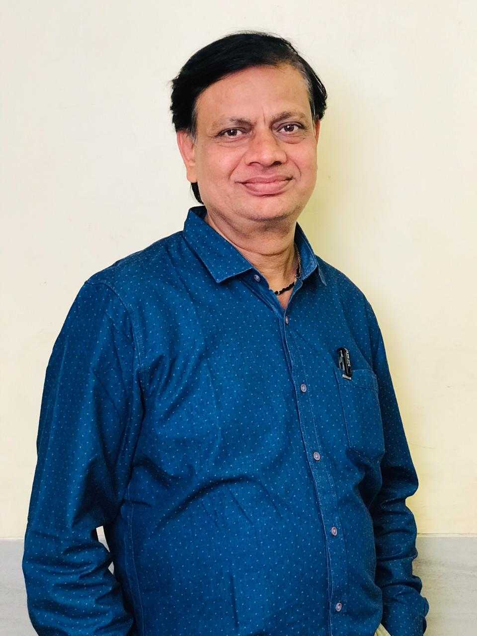 Vinod Chaurasia, smiling, in a blue shirt